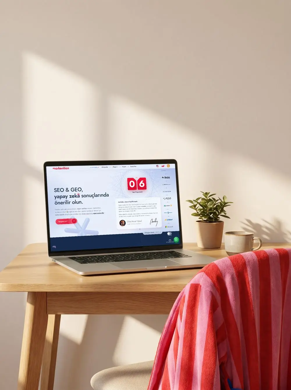 An open MacBook on a desk showing the markention.com home page